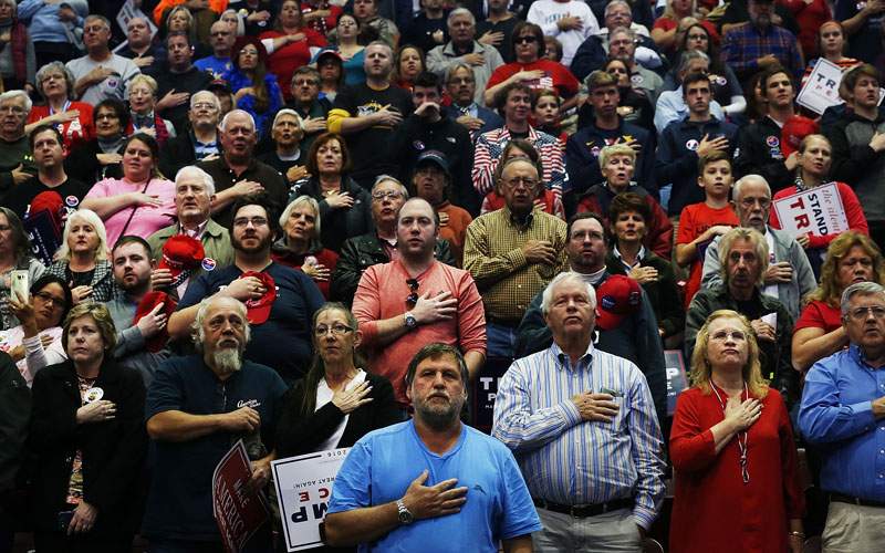 Donald Trump supporters wait for him to speak at a rally on November 4, 2016 in Hershey, Pennsylvania. Days before the presidential election, both Hillary Clinton and Donald Trump make their final pitches to the American people, with recent polls show a tightening race in crucial swing states. 