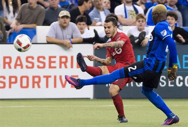 Montreal Impact's Ambroise Oyongo, right, challenges Toronto FC's Sebastian Giovinco during first half soccer action of the first leg of the MLS Eastern Conference final at the Olympic Stadium in Montreal, Tuesday, November 22, 2016. THE CANADIAN PRESS/Graham Hughes.