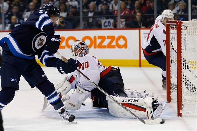 Washington Capitals goaltender Braden Holtby (70) stops Winnipeg Jets' Nikolaj Ehlers (27) during second period NHL action in Winnipeg on Tuesday, November 1, 2016.