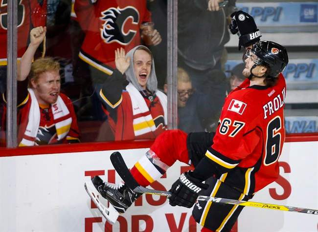 Calgary Flames’ Michael Frolik, from the Czech Republic, celebrates his game-winning overtime goal against the Arizona Coyotes during an NHL hockey game in Calgary, Wednesday, Nov. 16, 2016.