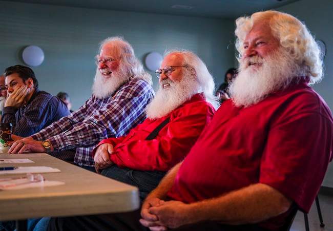Santa Clauses Bob Slocombe, left, Dan Dickison, centre, and Jeff Badyk listen to instructors at Santa School in Calgary, Alta., Friday, Oct. 21, 2016.

