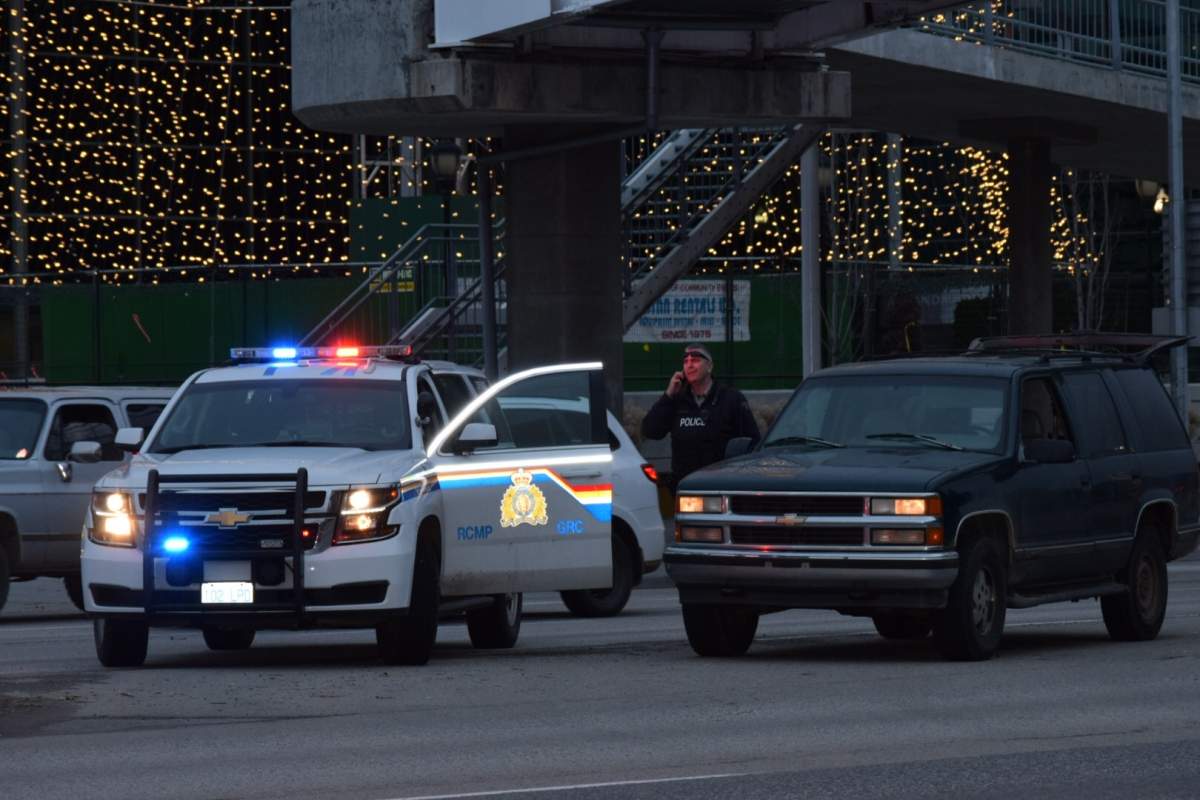 Police surround the area around Parkinson Recreation Centre in Kelowna Sunday afternoon as they search for the suspect of a possible stolen vehicle. 