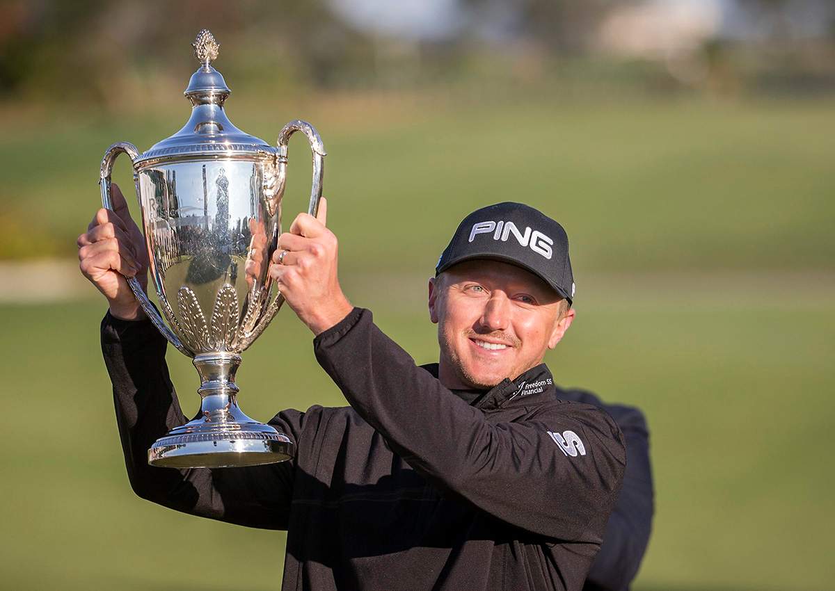 Mackenzie Hughes, of Canada, poses with the trophy after winning the playoff round at the RSM Classic golf tournament, Monday, Nov. 21, 2016, in St. Simons Island, Ga. 