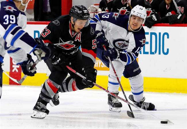 Winnipeg Jets' Brandon Tanev battles with Jeff Skinner of the Carolina Hurricanes during the second period of an NHL hockey game on Nov. 20, 2016, in Raleigh, N.C.
