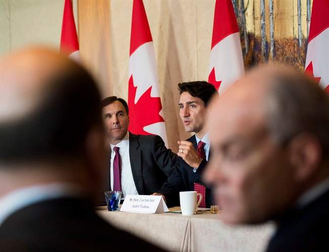 Prime Minister Justin Trudeau, back right, and Finance Minister Bill Morneau, back left, participate in a infrastructure round table in Toronto, Nov. 14, 2016.