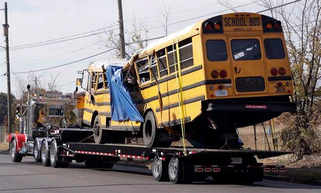 In this Nov. 22, 2016, file photo, a school bus is carried away in Chattanooga, Tenn., from the site where it crashed, killing several young students.