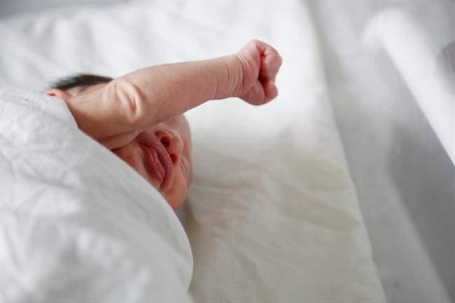 In this July 26, 2016 file photo, a newborn baby with microcephaly rests at a maternity ward of the University Hospital in Tegucigalpa, Honduras. Researchers say the severe birth defect caused by Zika infection may not be apparent at birth but develop months afterward, further confirmation that the virus can cause unseen damage to developing babies.
