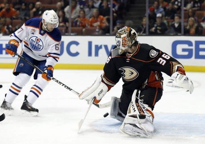 Anaheim Ducks goalie John Gibson, right, blocks a shot by Edmonton Oilers left wing Benoit Pouliot during the first period of an NHL hockey game in Anaheim, Calif., Tuesday, Nov. 15, 2016. 