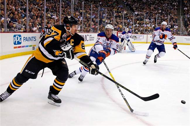 Pittsburgh Penguins' Sidney Crosby (87) gets off a pass in front of Edmonton Oilers' Connor McDavid (97) during the second period of an NHL hockey game in Pittsburgh, Tuesday, Nov. 8, 2016.