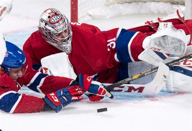 Montreal Canadiens defenceman Shea Weber helps goalie Carey Price.