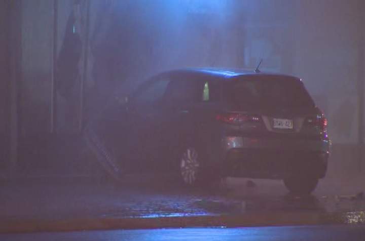 A car is lodged into a storefront on The Queensway in Etobicoke on Nov. 25, 2016.