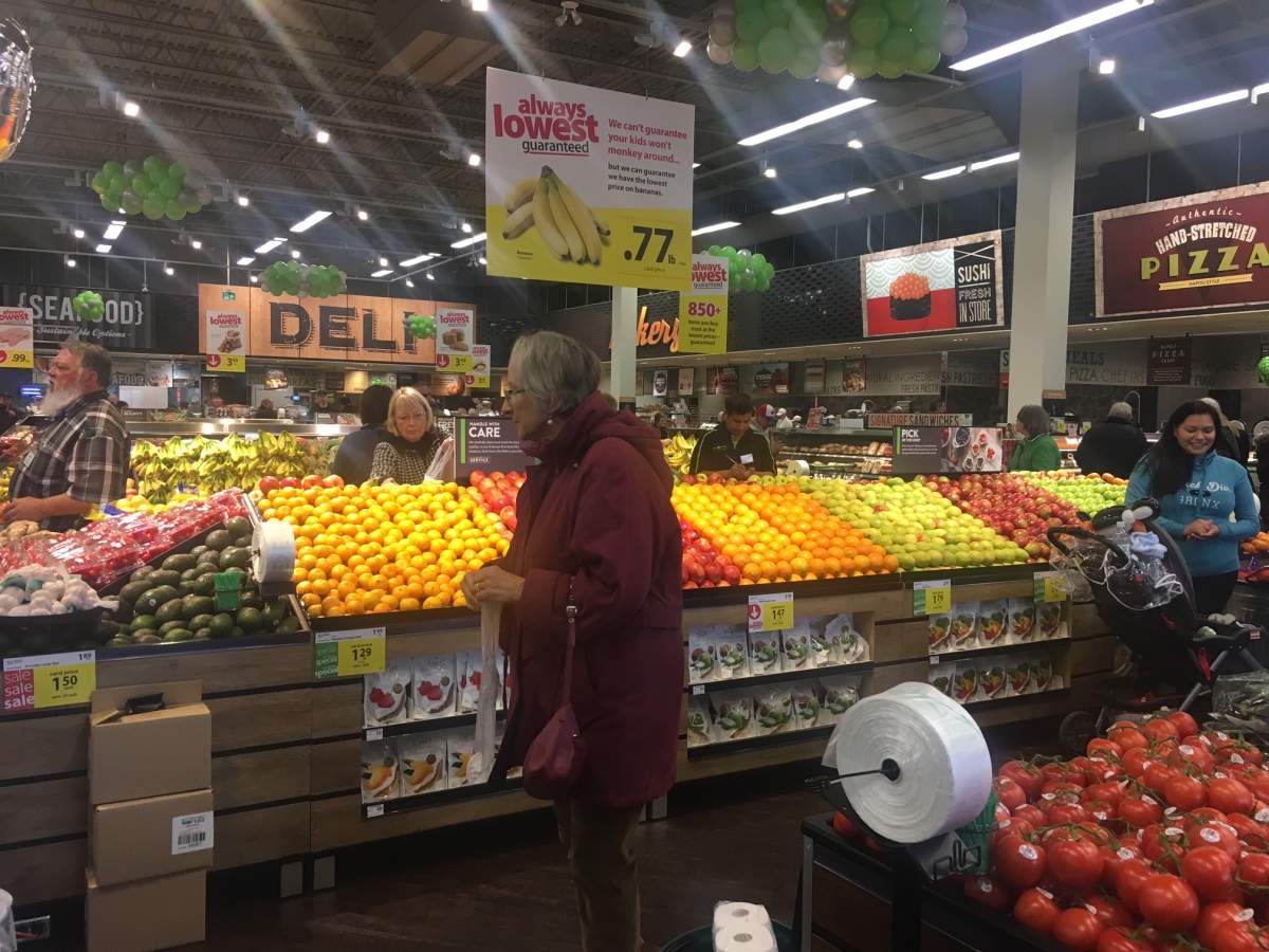 Shoppers look over the goods at Save-On-Foods.