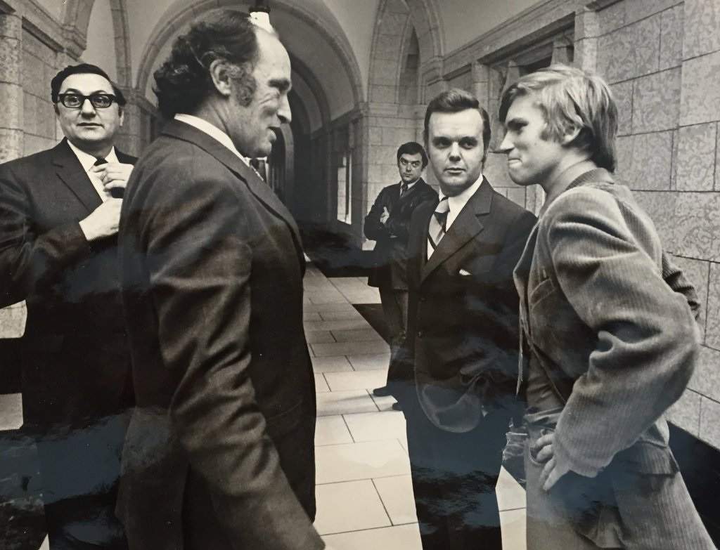 A young Tom Clark (right) chats with former prime minister Pierre Trudeau on Parliament Hill. (Credit: @TomClarkTV, Twitter)