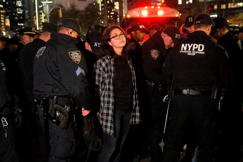 A woman is detained during a protest outside the Trump International Hotel and Tower following President-elect Donald Trump’s election victory in Manhattan, New York, U.S., November 9, 2016. REUTERS/Andrew Kelly
