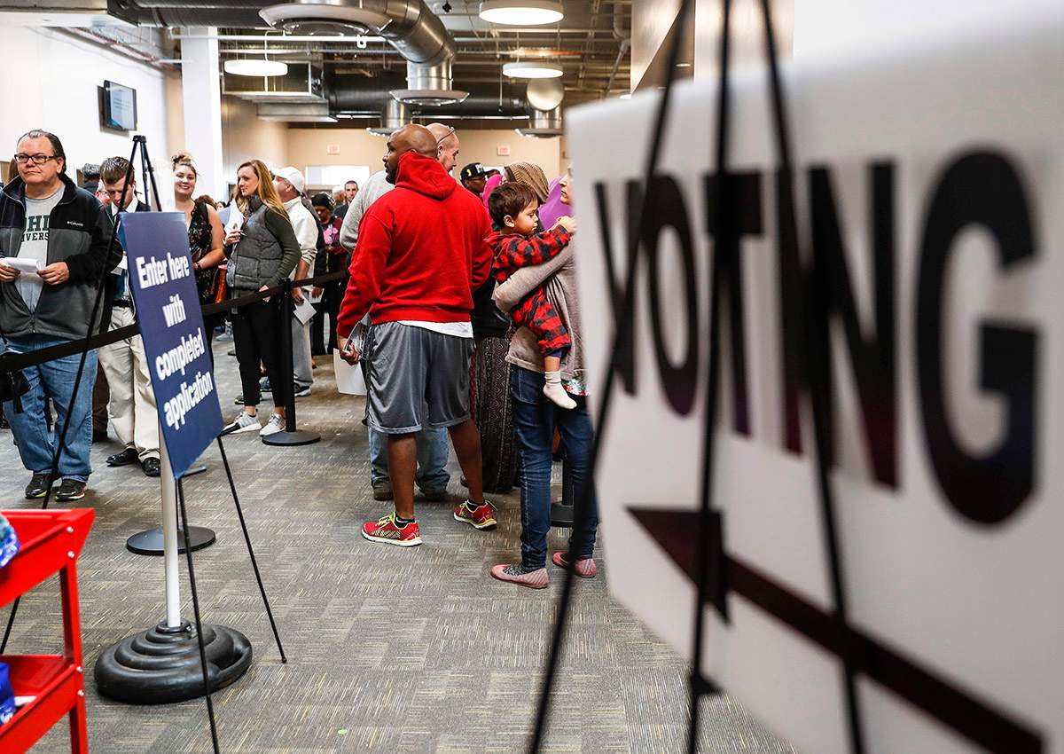 Early voters wait in line at the Franklin County Board of Elections, Monday, Nov. 7, 2016, in Columbus, Ohio.