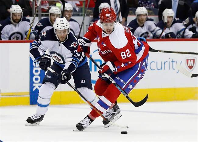 Winnipeg Jets defenseman Toby Enstrom (39) defends against Washington Capitals center Zachary Sanford (82) in the first period of an NHL hockey game, Thursday, Nov. 3, 2016, in Washington.