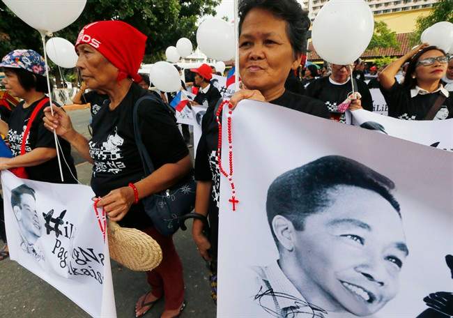 Supporters of the late Philippine dictator Ferdinand Marcos display his images prior to marching towards the Supreme Court for an overnight vigil Monday, Nov. 7, 2016 in Manila, Philippines. 