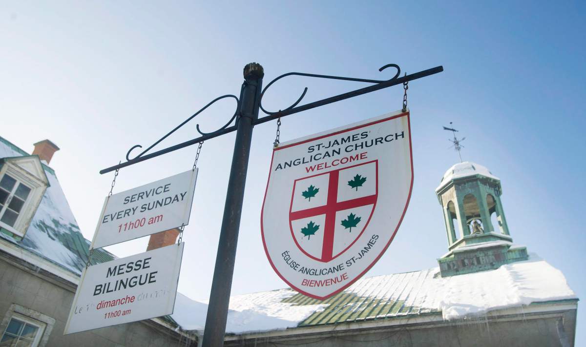 Signs in English and French hang outside St. James Anglican Church in Trois-Rivières, Que., Sunday, January 25, 2015.   The Nova Scotia and Quebec governments have signed an agreement aimed at preserving Canada's French-speaking communities. 