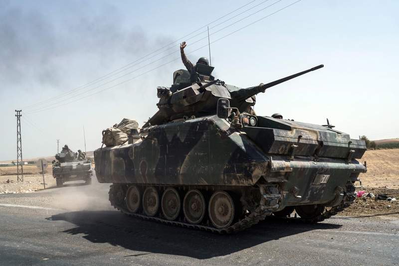 Turkish troops head to the Syrian border, in Karkamis, Turkey, Saturday, Aug. 27, 2016. 