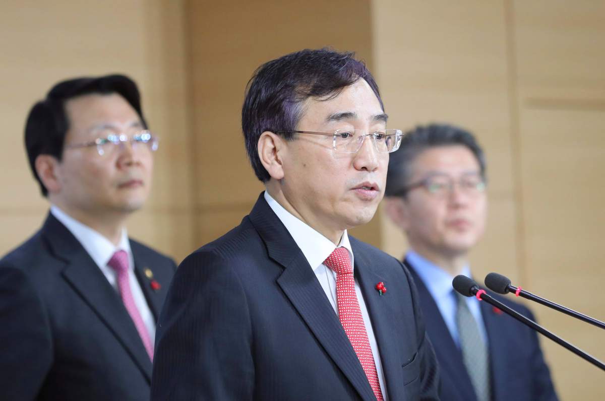Lee Sukjoon, center, minister of the Office for Government Policy Coordination, answers a reporters' questions after announcing about sanctions on North Korea at the government complex in Seoul, South Korea, Friday, Dec. 2, 2016. 