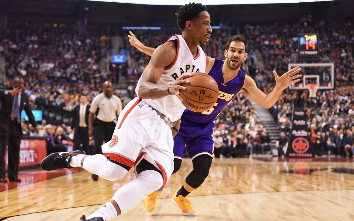 Toronto Raptors guard DeMar DeRozan drives past Los Angeles Lakers guard Jose Calderon during first half NBA basketball action in Toronto on Friday, December 2, 2016. 