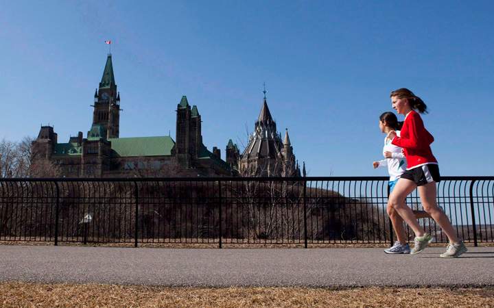 Joggers make their way through Majors Hill Park in downtown Ottawa in view of Parliament Hill on Wednesday, March 17, 2010. 