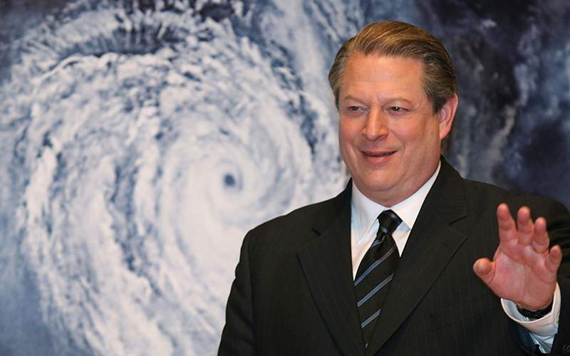 Former Vice President Al Gore acknowledges spectators in front of a poster of his starring documentary film "An Inconvenient Truth" on global warming before its screening during the Japan Premier at a theater in Tokyo. 