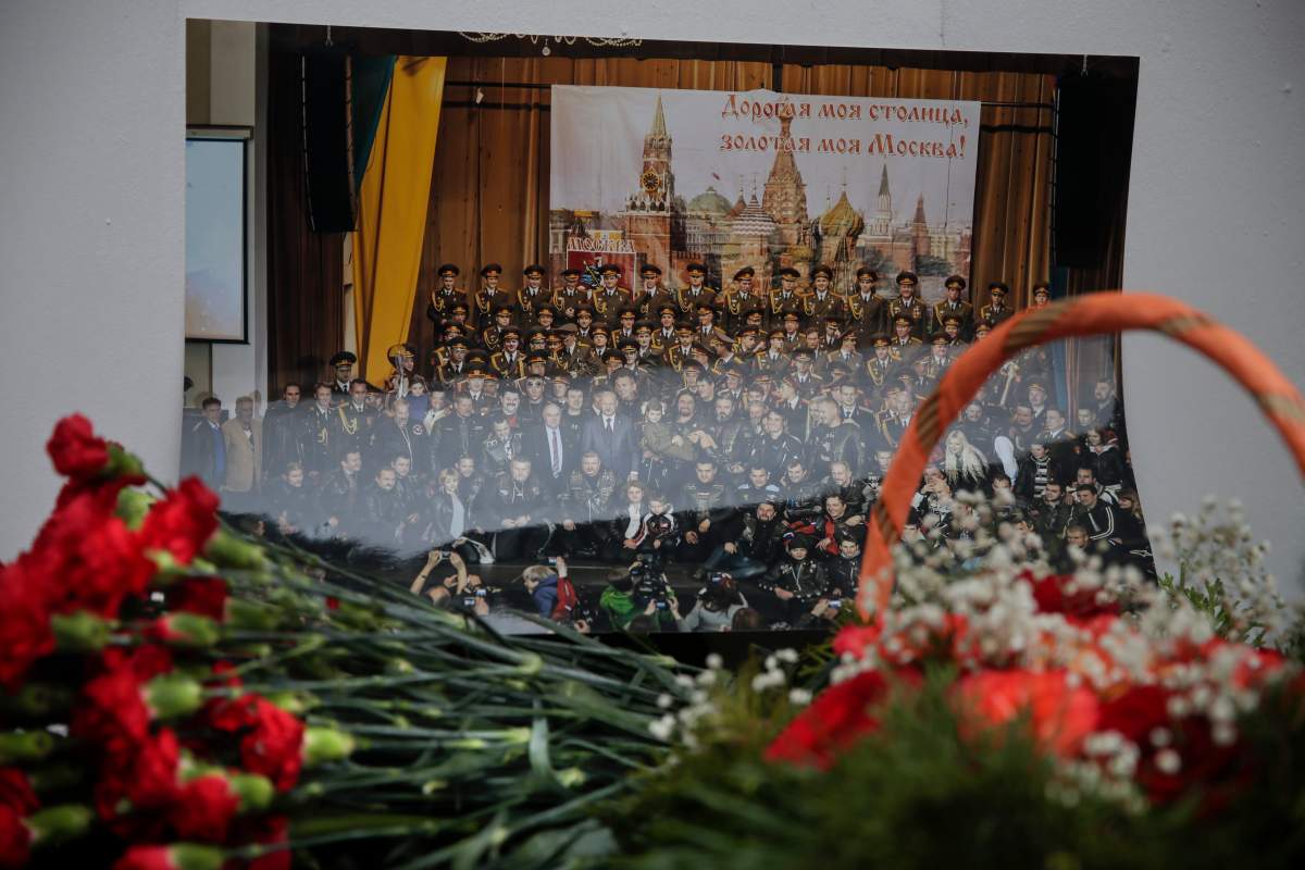 Flowers lay in front of a photo of a well-known military choir lays flowers at the military choir’s building in Moscow, Russia, Sunday, Dec. 25, 2016, after a plane carrying 64 members of the Alexandrov Ensemble, crashed into the Black Sea minutes after taking off from the resort city of Sochi. The Russian plane was headed for an air base in Syria with 92 people aboard, Russia’s Defense Ministry said.