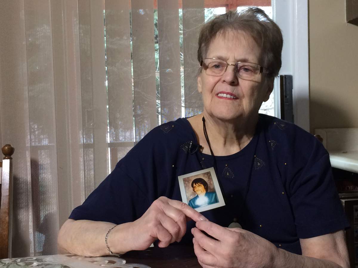 Agatha Syniak holds a picture of her son Dennis, taken on his 18th birthday. 
