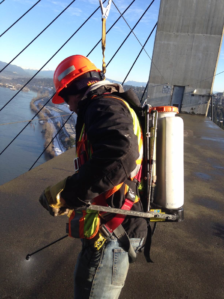 Crew member de-icing on Alex Fraser cross beam.