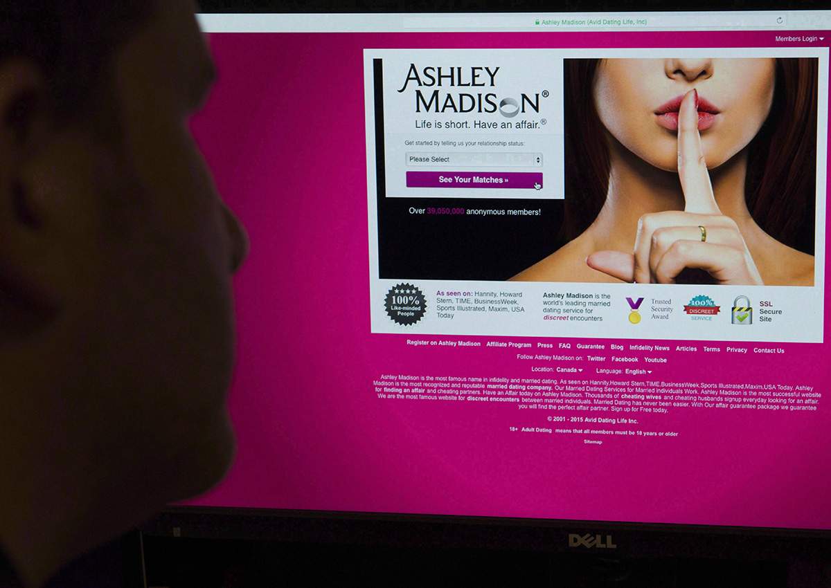 A man looks at the Ashley Madison website in this photo illustration in Toronto on August 20, 2015. 
