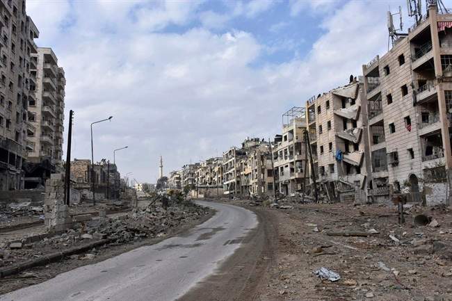 This photo released by the Syrian official news agency SANA, shows damaged buildings in the Ansari neighborhood, east Aleppo, Syria, Friday, Dec 23, 2016.