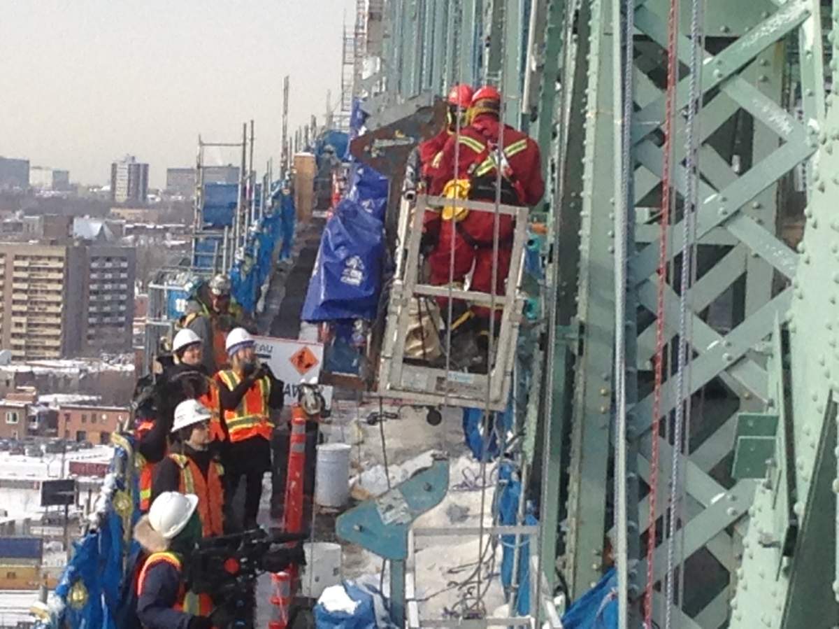 Workers battle Mother Nature to install over 2,000 lights on the Jacques-Cartier Bridge for Montreal's 375th anniversary, Monday, December. 19, 2016.