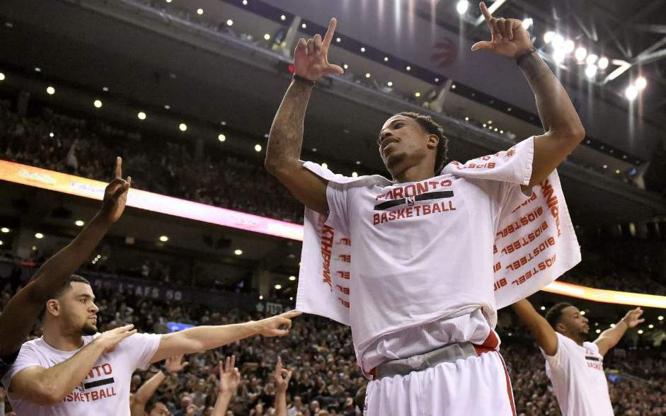 Toronto Raptors guard DeMar DeRozan celebrates alongside fellow Raptors Fred VanVleet and Norman Powell during the second half of an NBA basketball game against the Atlanta Hawks on Saturday, Dec. 3, 2016, in Toronto. 