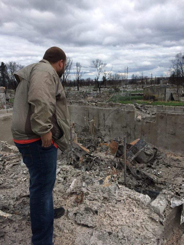 Fort McMurray resident Chris Flett surveys what’s left of his home following the May wildfires