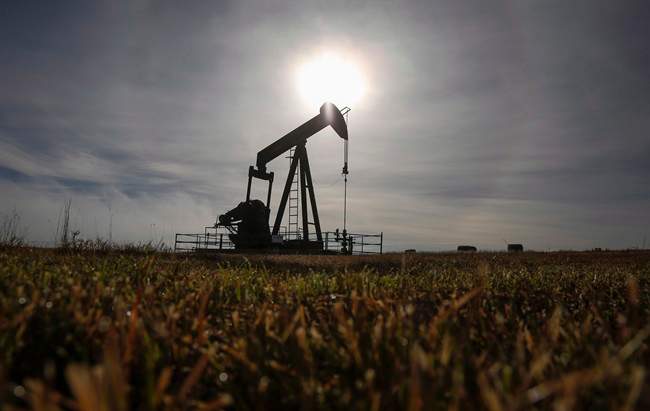 A pumpjack works at a well head on an oil and gas installation near Cremona, Alta., Saturday, Oct. 29, 2016.