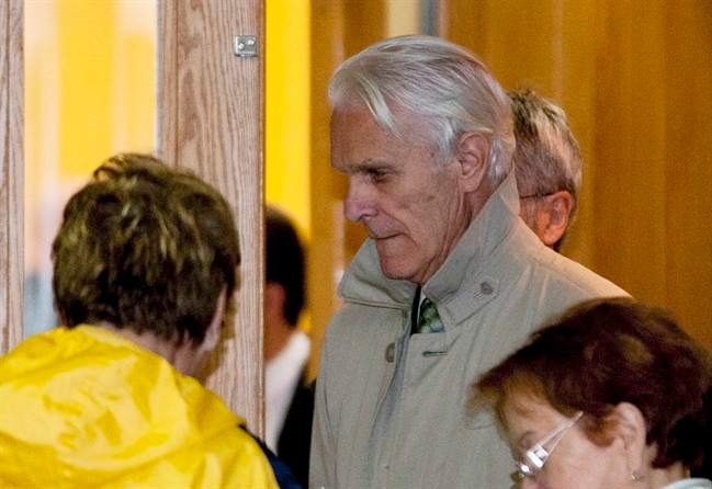 Former judge Jacques Delisle, centre, walks out of a courtroom at his murder trial Tuesday, May 8, 2012 in Quebec City.
