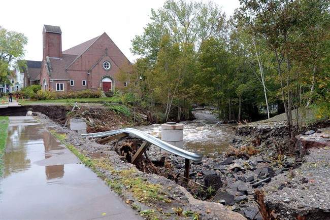 FILE: A washed out road and damaged guard rail is shown in Sydney, N.S., Tuesday, Oct.11, 2016. The estimated cost for damage caused by the Thanksgiving Day floods in Cape Breton could exceed $15 million, says the Nova Scotia government.