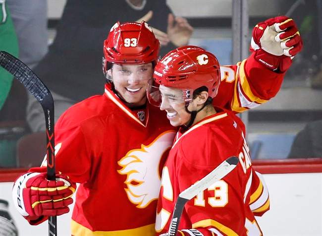 Calgary Flames' Sam Bennett, left, celebrates his goal with Johnny Gaudreau during second period NHL hockey action against the Winnipeg Jets in Calgary, Saturday, Dec.