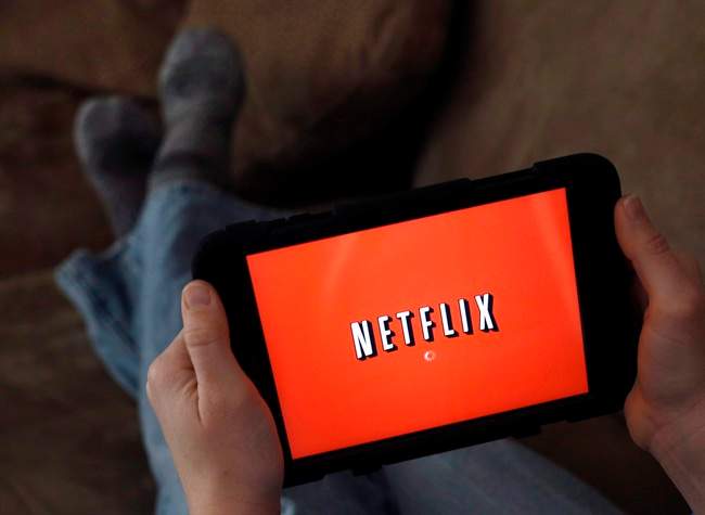 In this photo, a person displays Netflix on a tablet in North Andover, Mass.