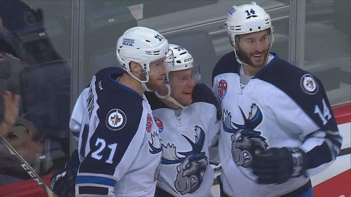 Manitoba Moose forward Dan DeSalvo celebrates his third period goal with teammates on Sunday.