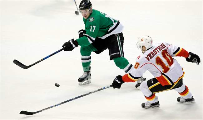 Calgary Flames right wing Kris Versteeg (10) and Dallas Stars center Devin Shore (17) skate for the puck during the second period of an NHL hockey game in Dallas, Tuesday, Dec. 6, 2016. 