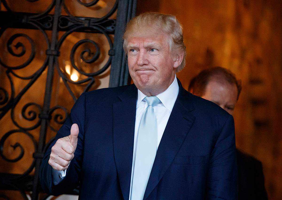President-elect Donald Trump gives a thumbs up to reporters at Mar-a-Lago, Wednesday, Dec. 28, 2016, in Palm Beach, Fla. 