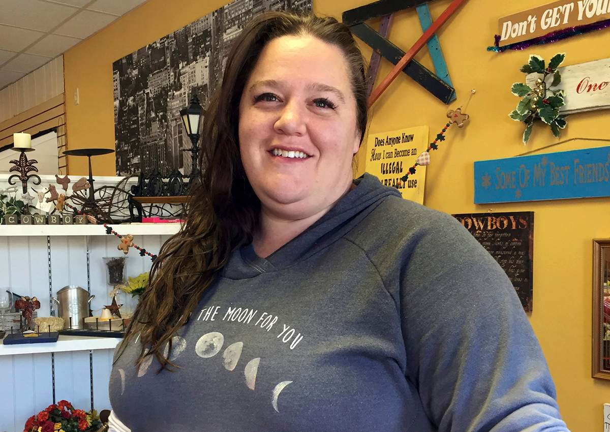 In this Dec. 13, 2016 photo, Shay Chamberlain poses for a picture in her small clothing store and boutique in Menomonie, Wis. As each Cabinet announcement draws fresh criticism of Donald Trump's latest appointees, many Americans who voted for him, like Chamberlain, say the president-elect is doing what he promised to do: draining the swamp.