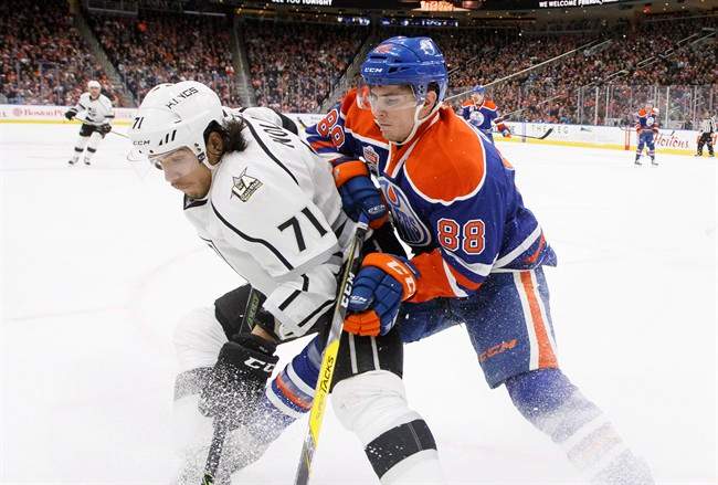 Los Angeles Kings' Jordan Nolan (71) and Edmonton Oilers' Brandon Davidson (88) battle in the corner during third period NHL action in Edmonton, Alta., on Thursday December 29, 2016. 