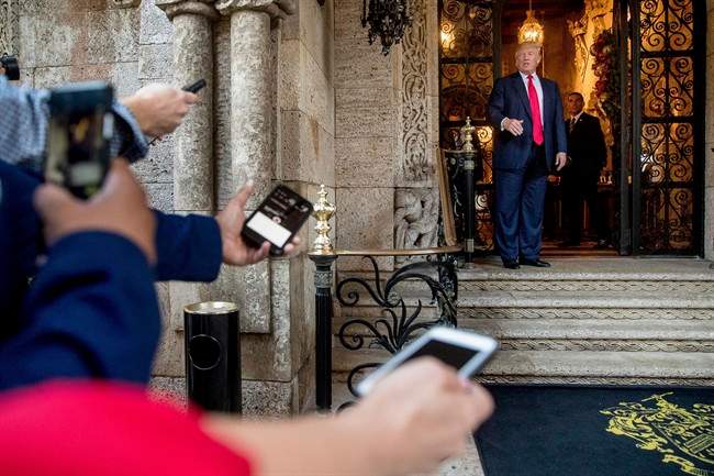 President-elect Donald Trump, right, speaks to members of the media after a meeting with admirals and generals from the Pentagon at Mar-a-Lago, in Palm Beach, Fla., Wednesday, Dec. 21, 2016.