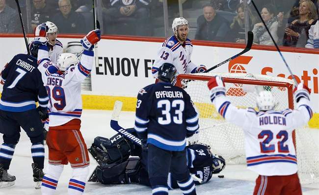 New York Rangers' J.T. Miller, Nicklas Jensen, Kevin Hayes and Nick Holden celebrate Hayes' game-winning goal against the Winnipeg Jets.