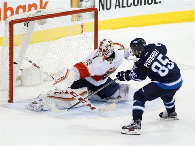 Winnipeg Jets' Mathieu Perreault scores the shootout winner against Florida Panthers goaltender Roberto Luongo on Dec. 15, 2016.