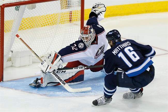Columbus Blue Jackets goaltender Sergei Bobrovsky saves the shot from Winnipeg Jets' Shawn Matthias during the third period of a NHL game in Winnipeg on Dec. 29, 2016. 