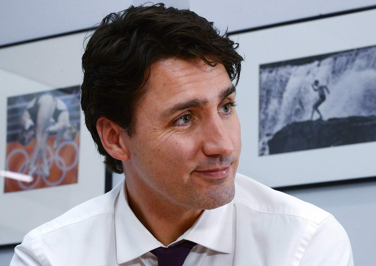 A picture of his father Prime Minister Pierre Trudeau in Guyana in 1974 hangs on the wall behind.